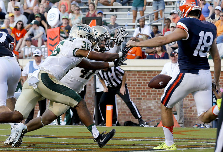 W&M safety DeAndre Houston-Carson blocks the UVA punt in the end zone for the safety. [Photo: MARK GORMUS/TIMES-DISPATCH]